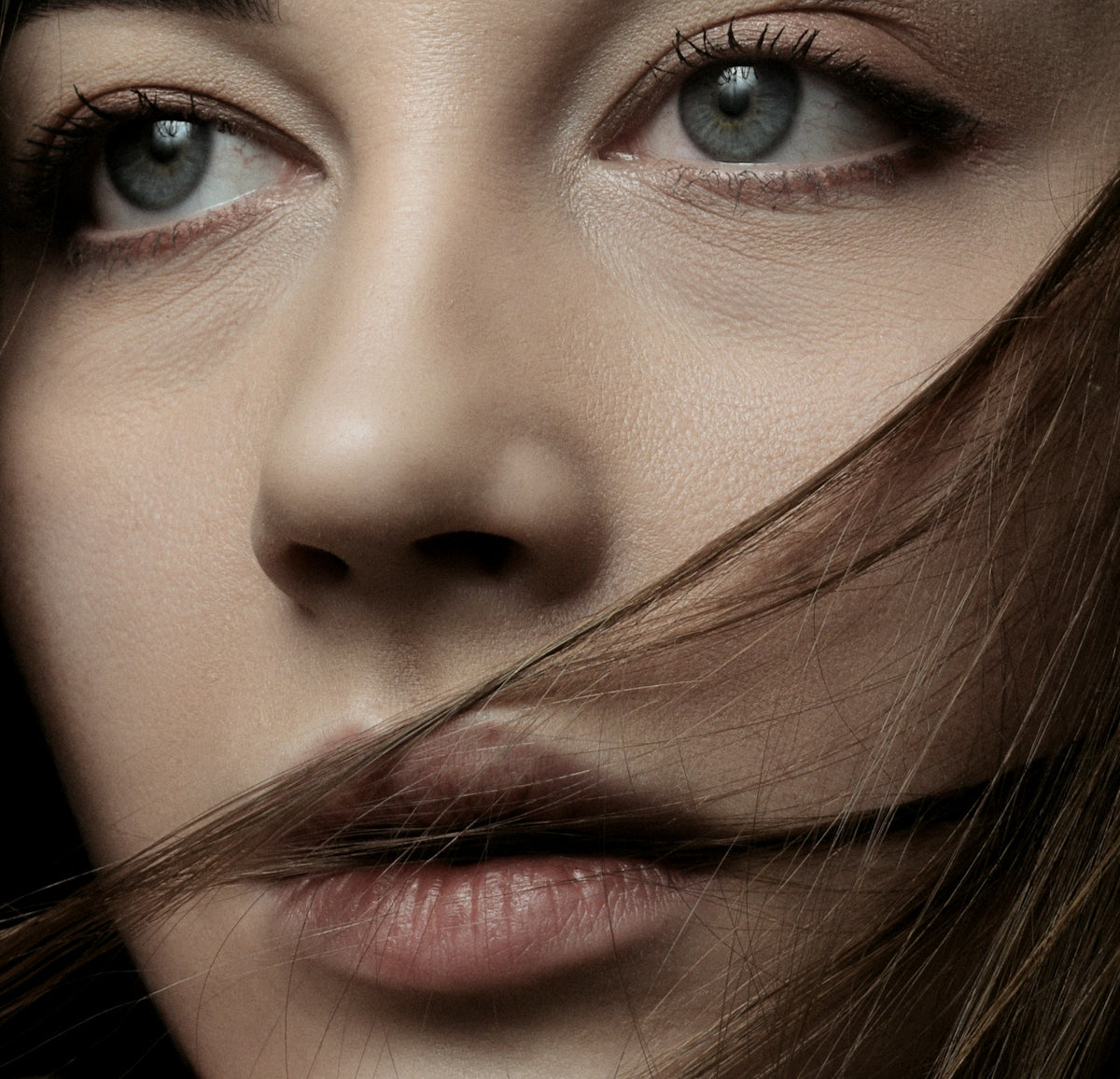 a close up of a woman's face with long hair